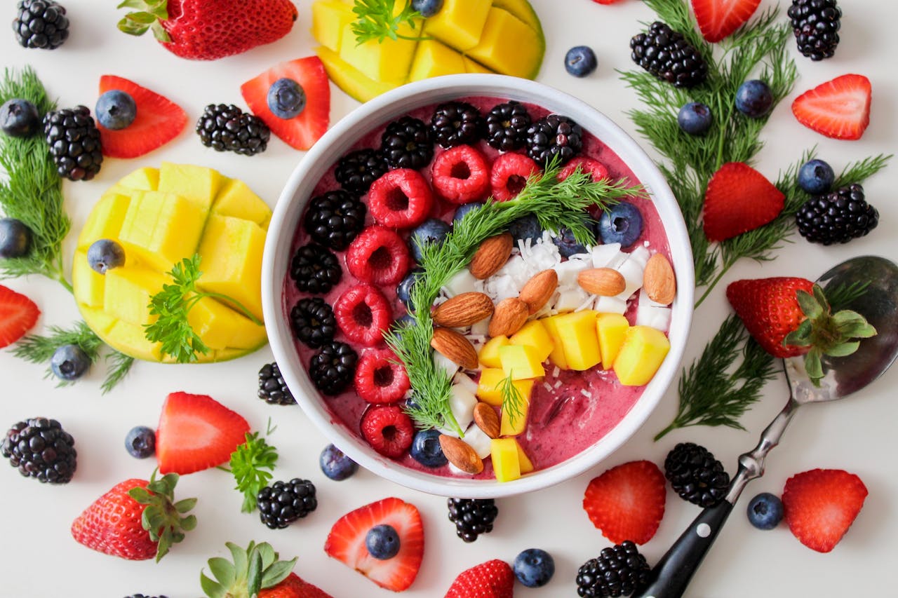 Top view of a bowl of yoghurt with berries and fruits