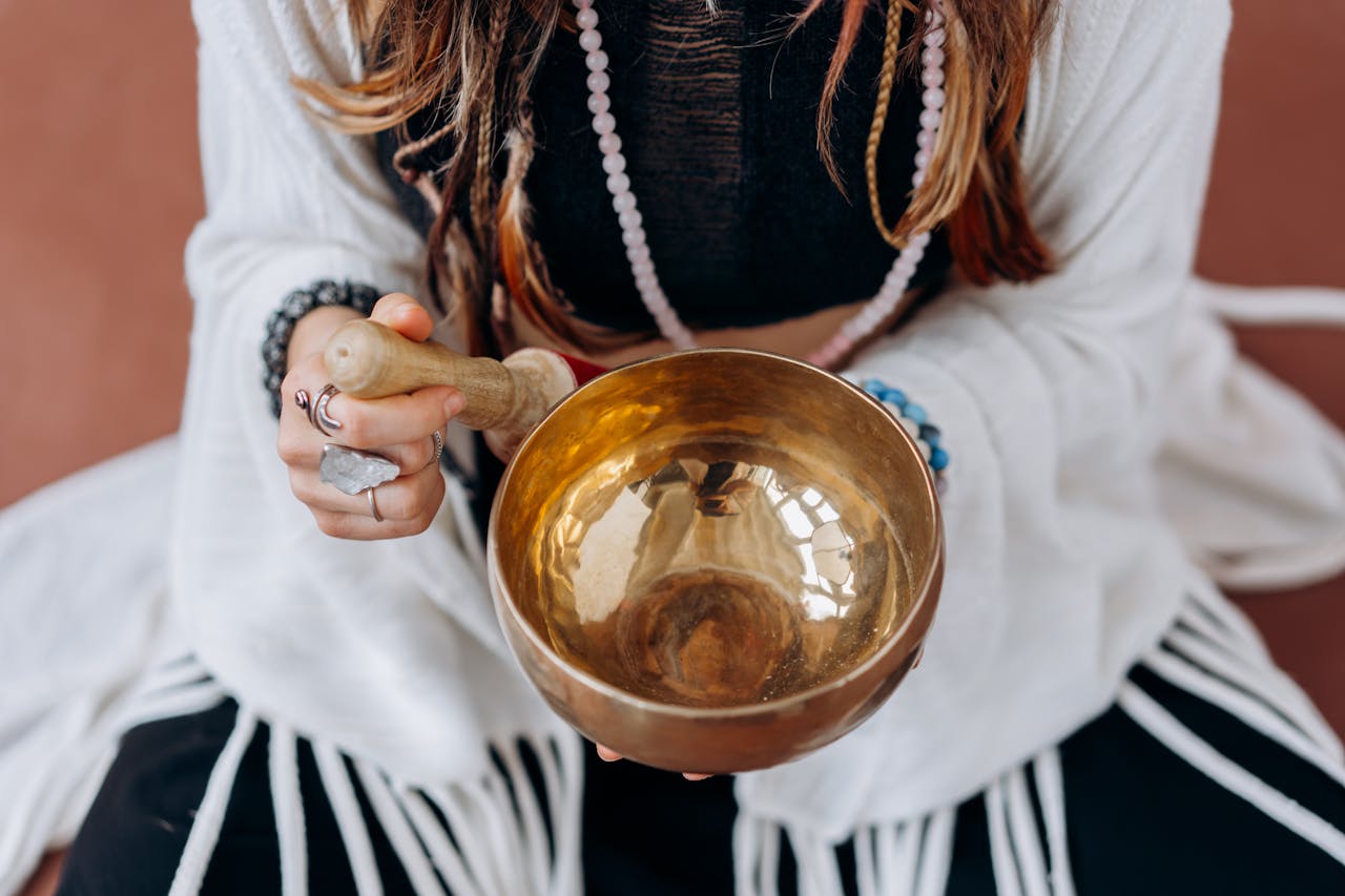 A woman plays singing bowl for reducing stress